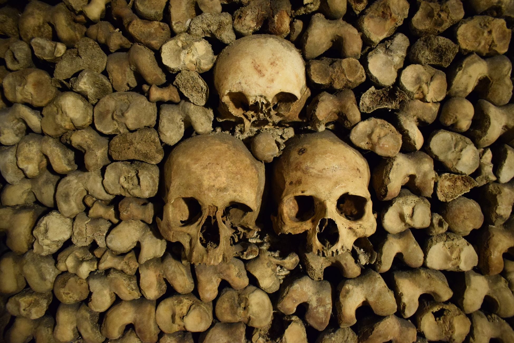Beneath the streets of Paris lie roughly 200 kilometres of tunnels holding the bones of around six million people, moved underground starting in 1786 to relieve overflowing cemeteries, and only a small lit fraction is open to visitors who descend 20 metres below the city.