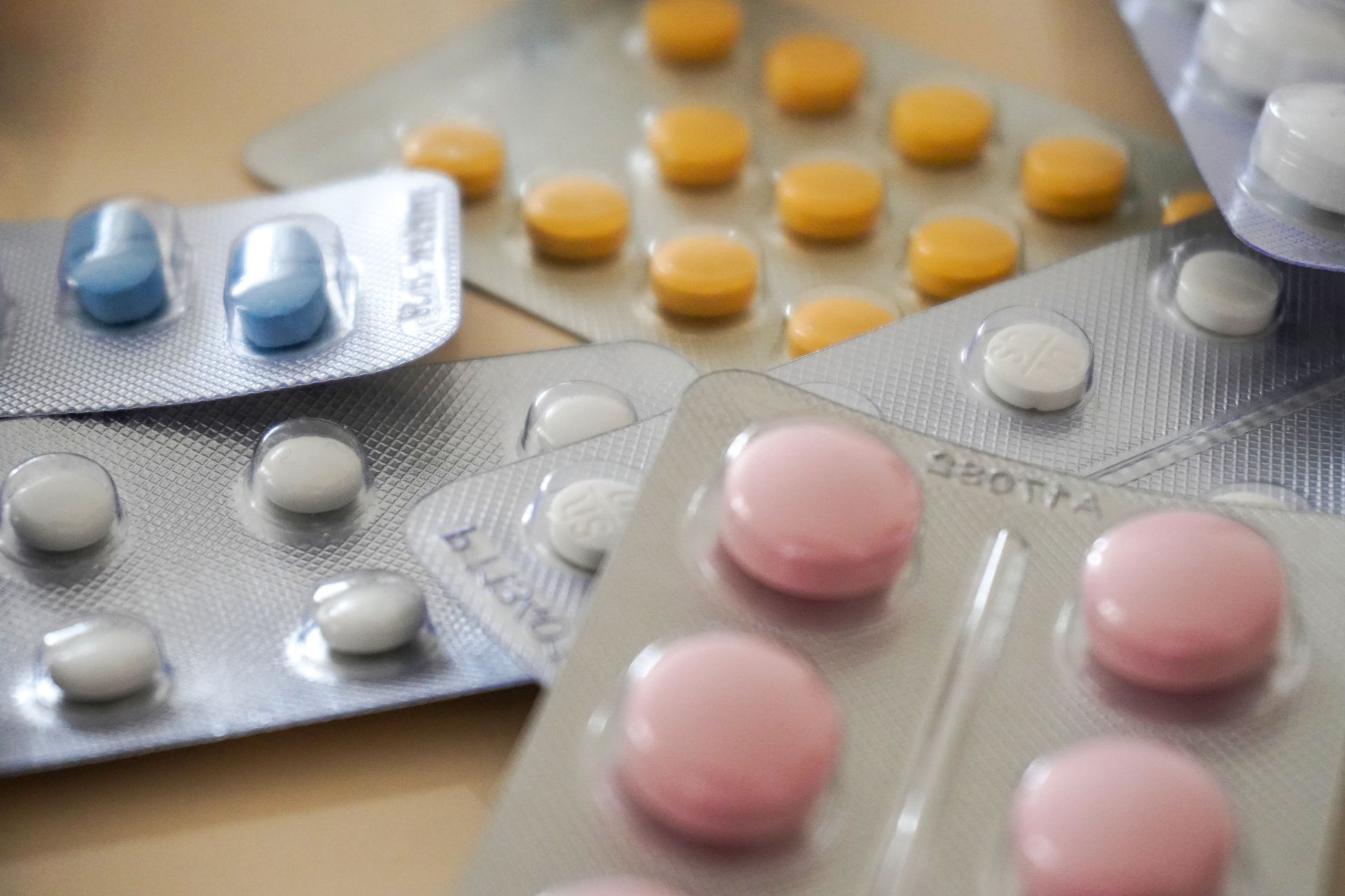 Close-up view of assorted colorful medication blister packs with diverse pills.