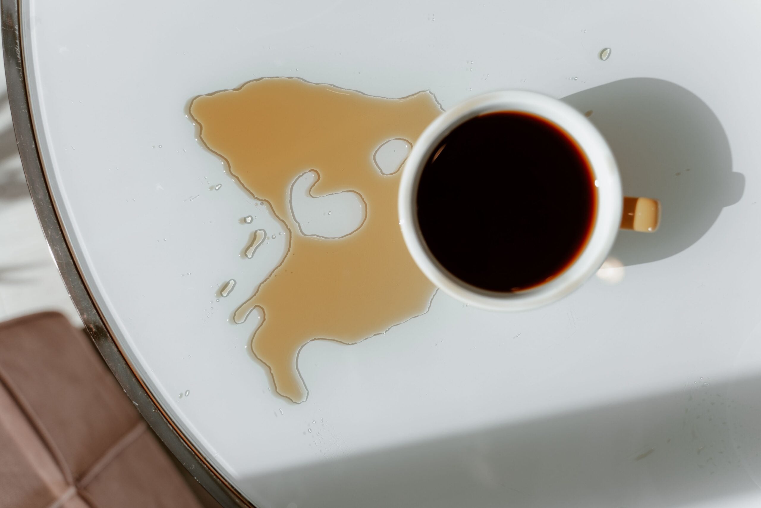 One of psychology’s strangest experiments found that spilling coffee made a highly competent person more likeable but did not rescue an average one, suggesting that imperfection is charming only after people have already been given a reason to trust the person underneath it